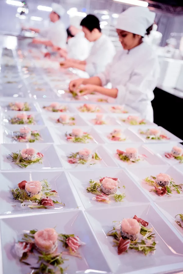 Brigade de cuisine dressant les entrées lors des préparatifs d'un gala au Palais des Congrès de Strasbourg